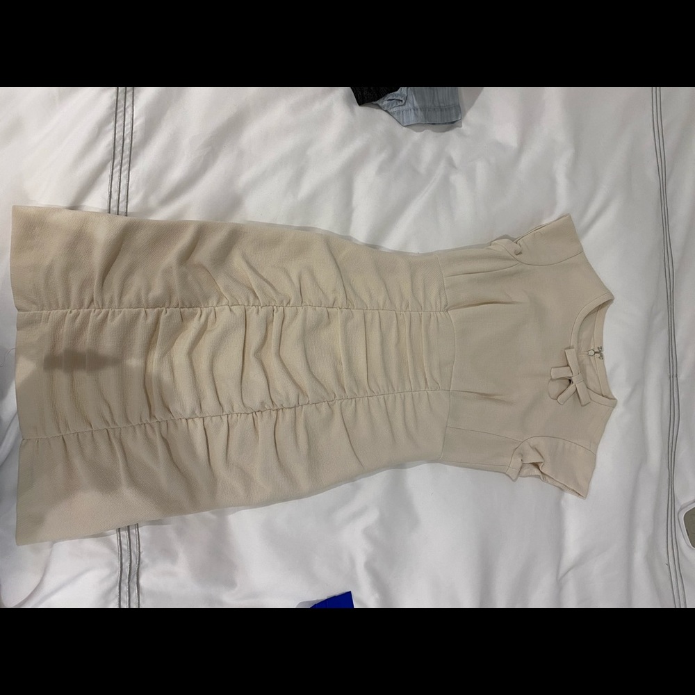 Beige dress with ruching and bow detail